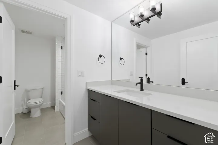 Floating vanity with a light-colored countertop and integrated sink