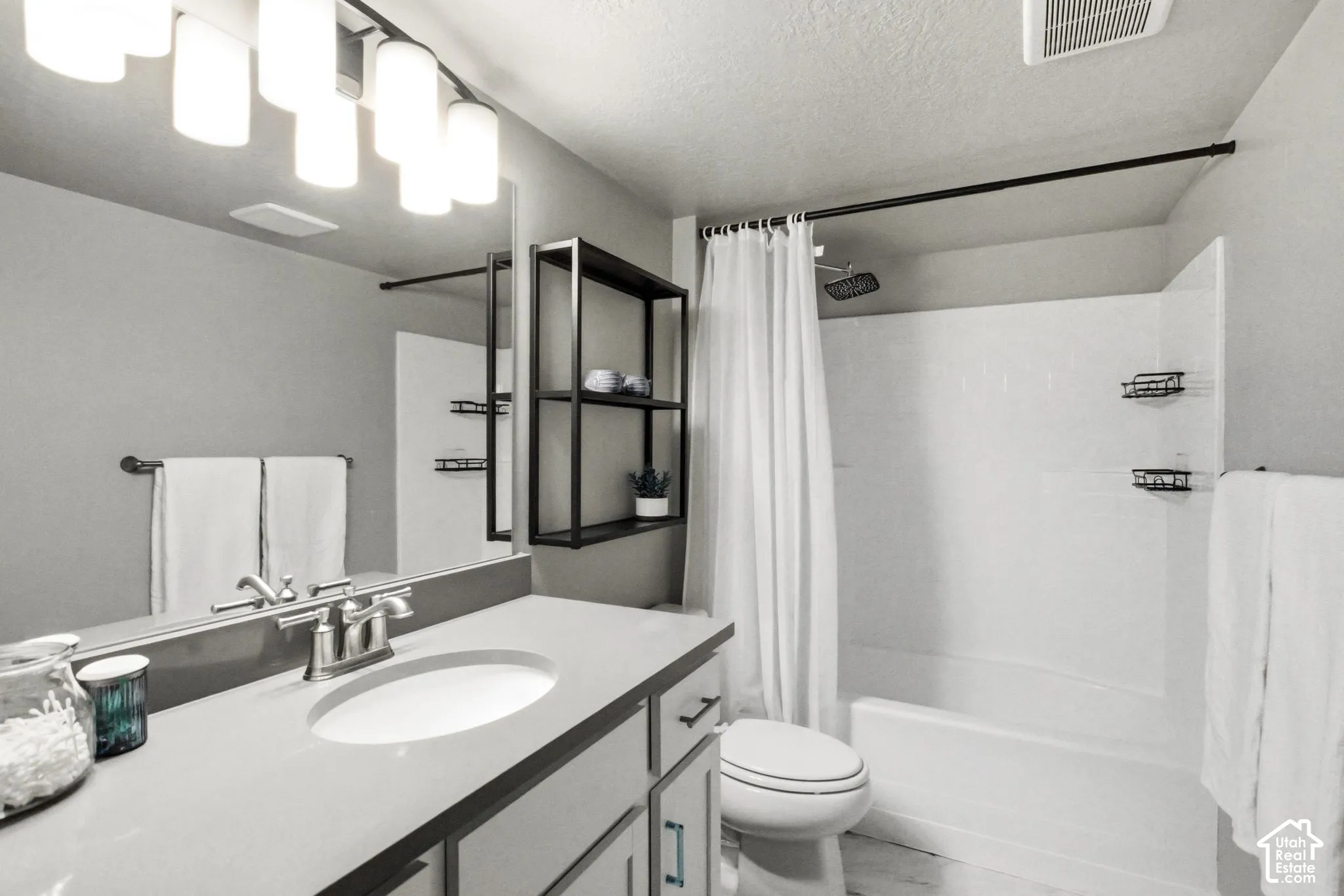 Modern bathroom featuring a floating vanity with rectangular vessel sink, quartz countertop, and chrome faucet fixtures