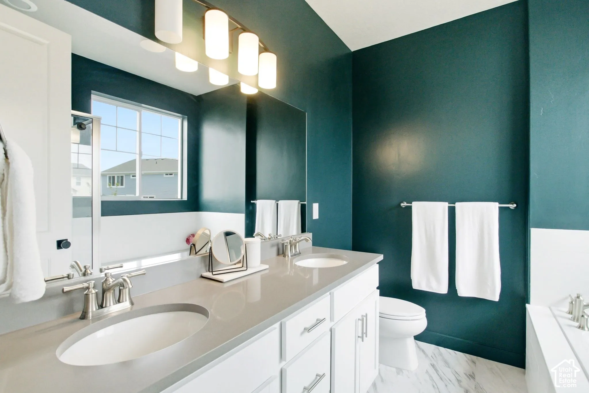 Dual vanity with undermount sinks, brushed nickel fixtures, and a light-toned countertop