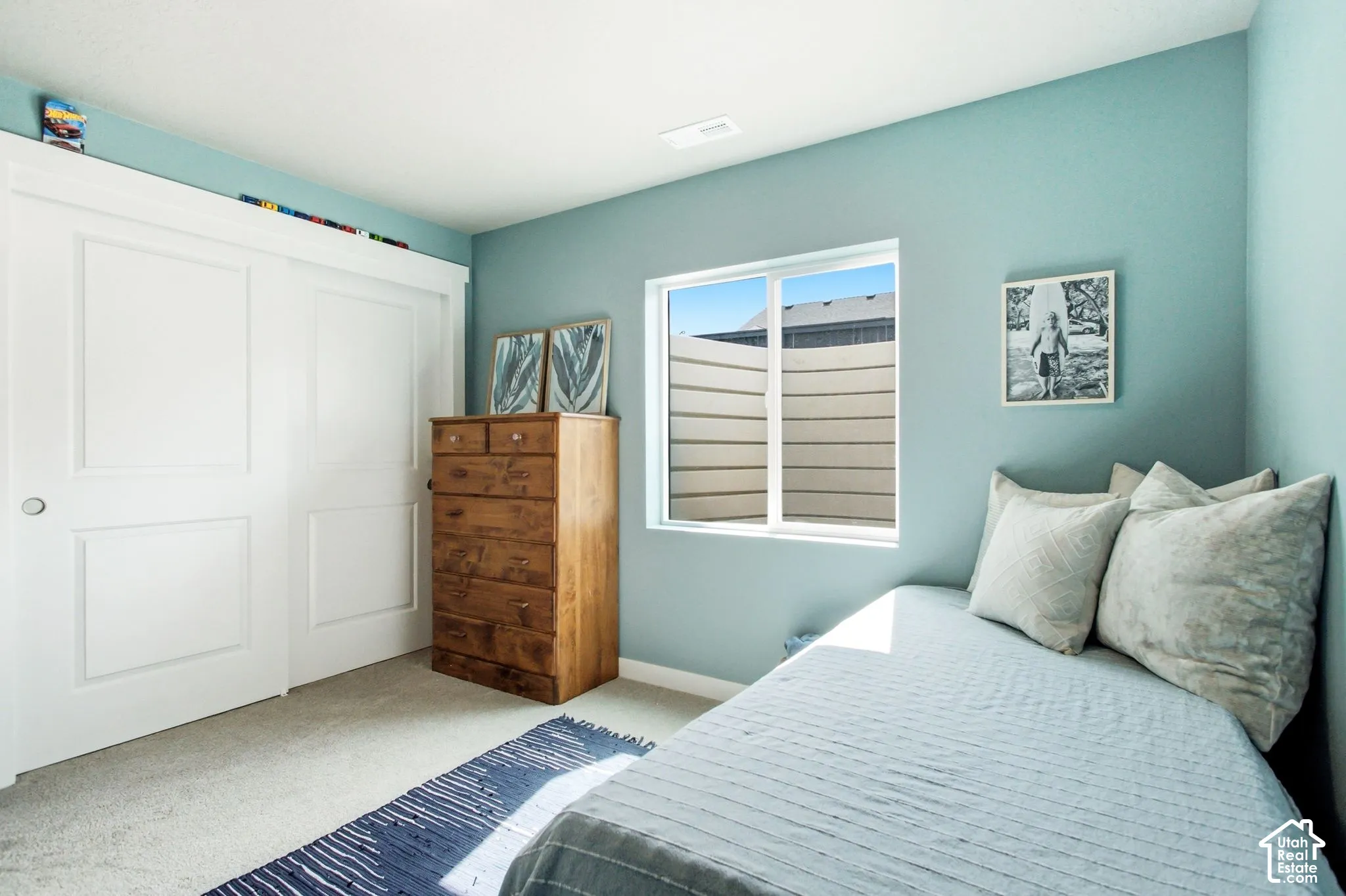 Recessed lighting, light-toned carpeting, and a window with a white frame