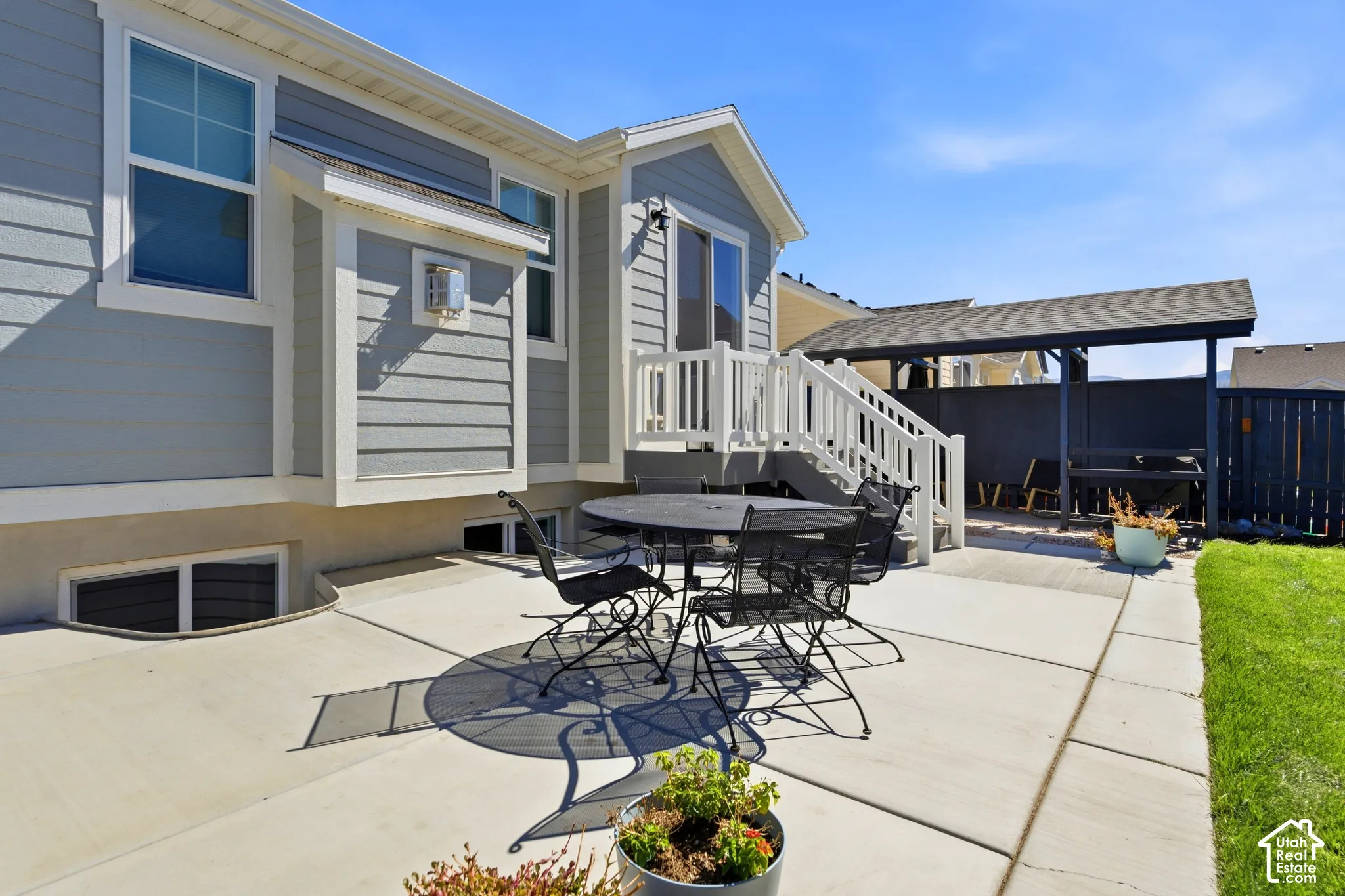 Concrete patio with a covered outdoor structure, exterior siding, and white window trim