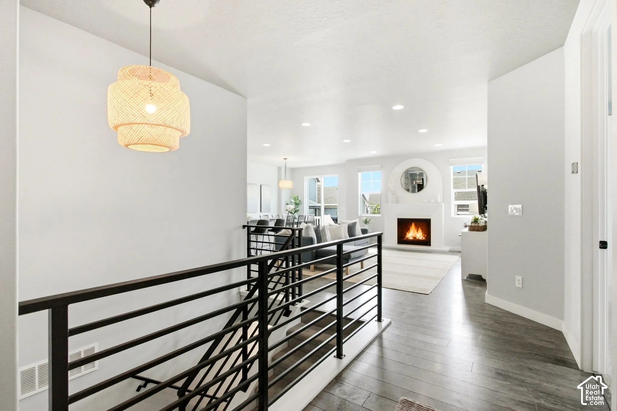 Open-concept living area with a fireplace and multiple windows