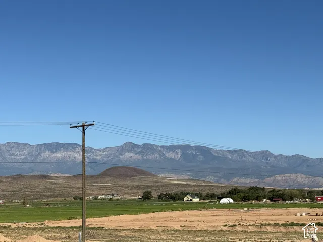 Expansive arid landscape featuring distant mountains and a clear sky