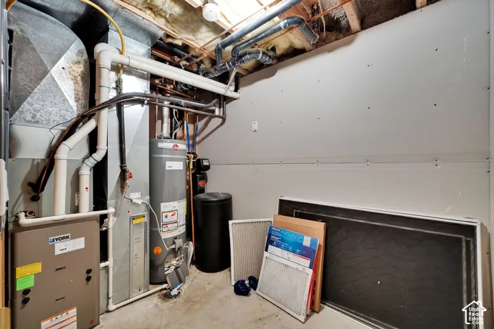 Utility area featuring a water heater, furnace, and water softener