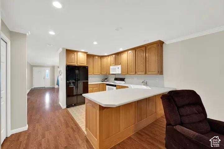Kitchen featuring wood cabinetry, solid surface countertops, a built-in sink, and permanent overhead lighting