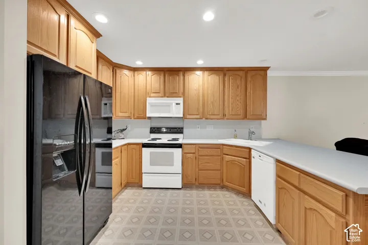 Kitchen featuring wood cabinetry, white countertops, built-in appliances, recessed lighting, and patterned flooring