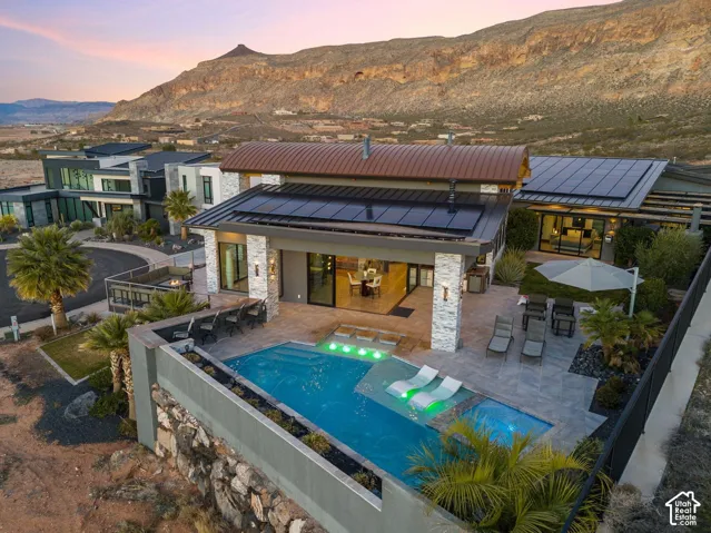 Modern exterior featuring stone accents and expansive solar panels