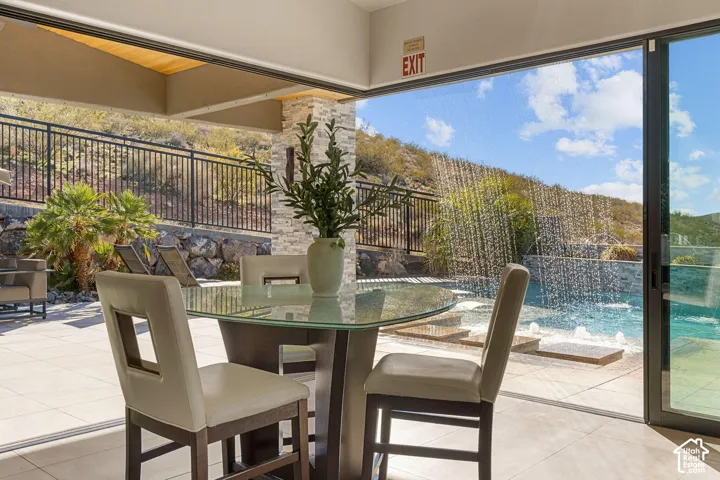 Expansive outdoor living area with a built-in water feature and pool