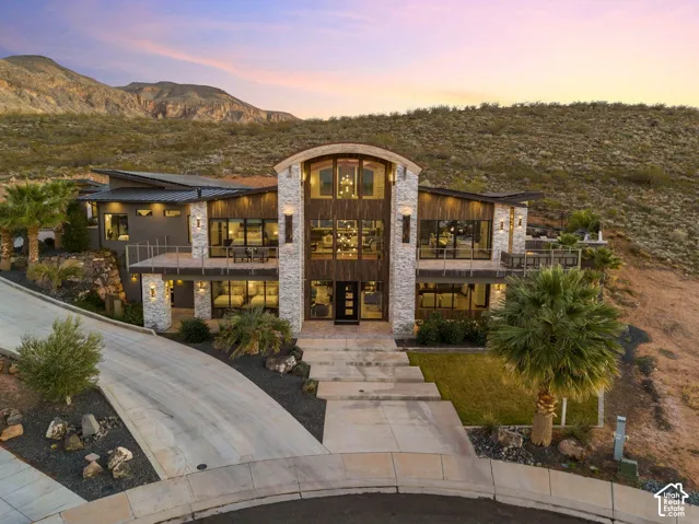 Contemporary multi-level exterior with stone and wood-paneled accents