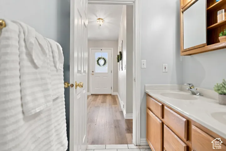 Bathroom vanity with dual sinks, chrome fixtures, and a light-toned countertop