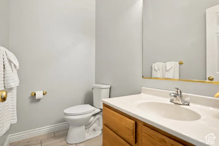 Wood-finish cabinetry with an integrated sink and chrome faucet, set against light gray walls