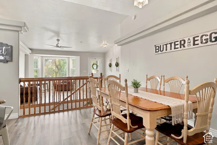 Dining area featuring wood-finish flooring and a vaulted ceiling