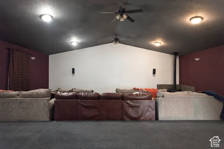 Pitched ceiling with recessed lighting and ceiling fans