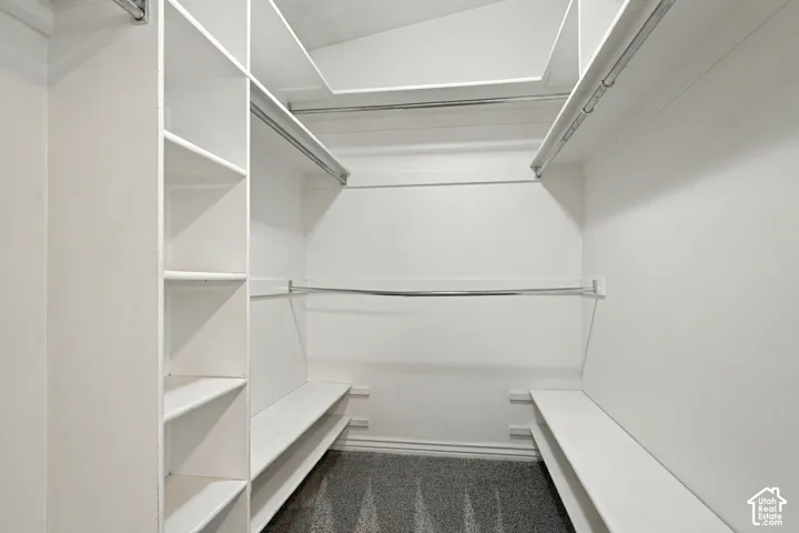 Built-in closet system with shelving, hanging rods, and integrated benches