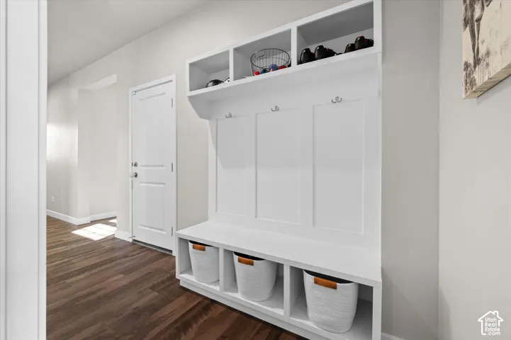 Built-in mudroom bench with cubbies, overhead storage, and coat hooks