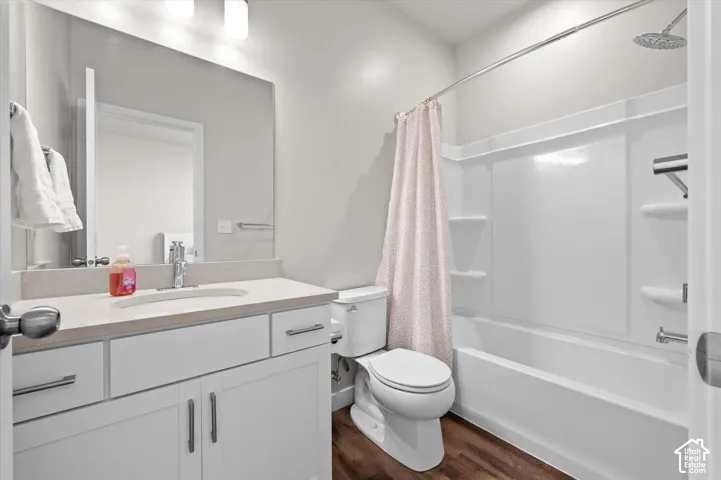 White vanity with stone-finish countertop and undermount sink