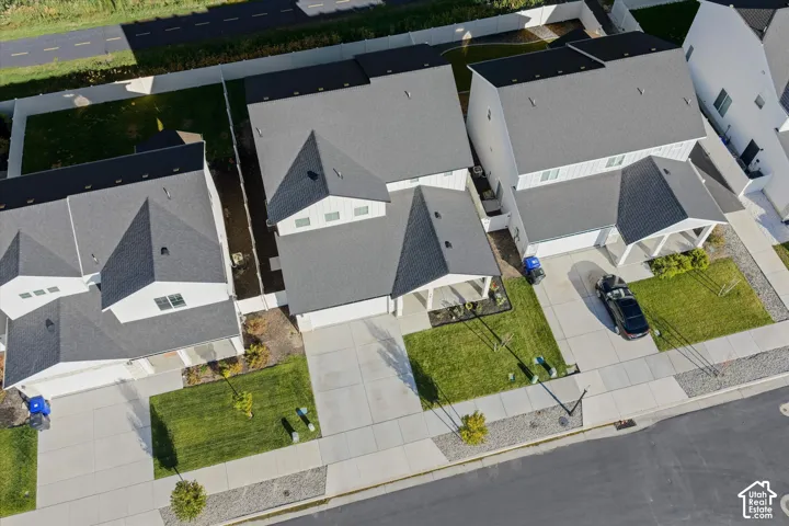 Aerial view of a modern residential community featuring multiple contemporary homes with clean-lined architecture, pitched rooflines, and neutral exterior finishes