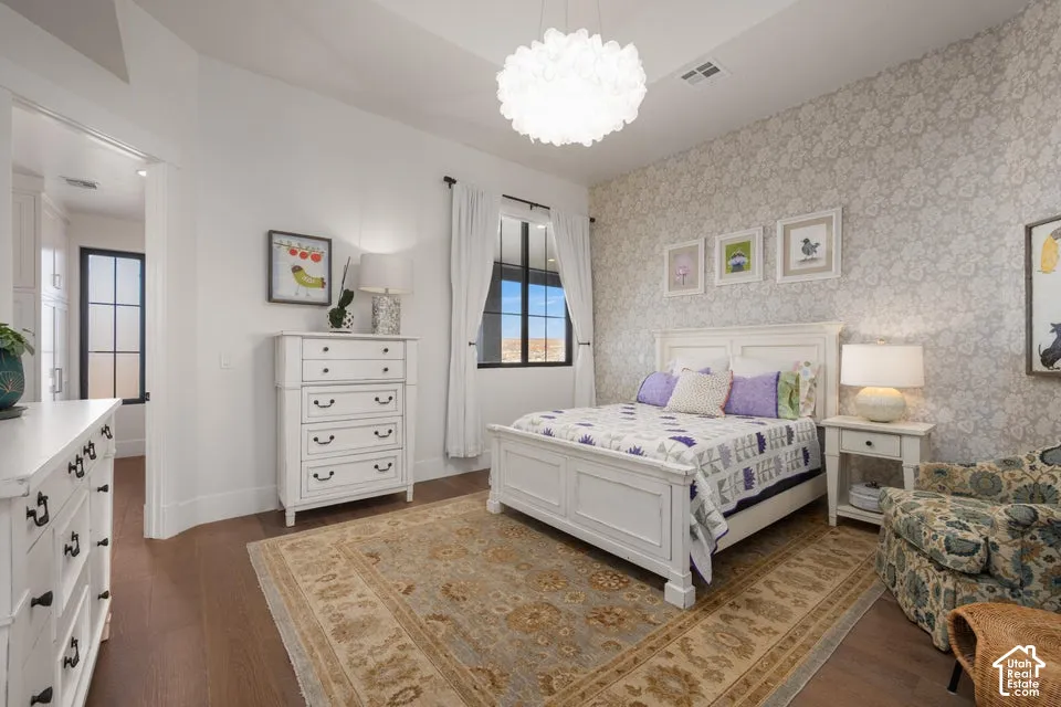 Recessed lighting, wood-finish flooring, and a decorative ceiling fixture