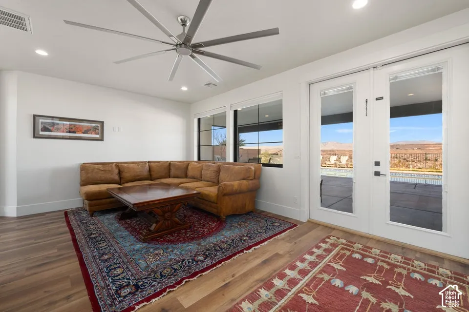 Wood-finish flooring, recessed lighting, and a large ceiling fan