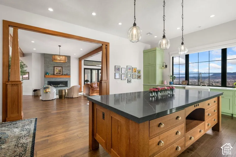 Kitchen island with a dark countertop and wood-finish cabinetry