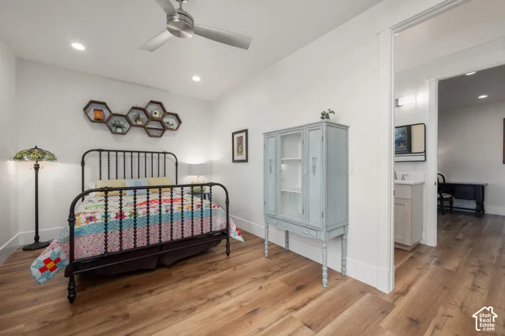 Wood-finish flooring, recessed lighting, and a ceiling fan
