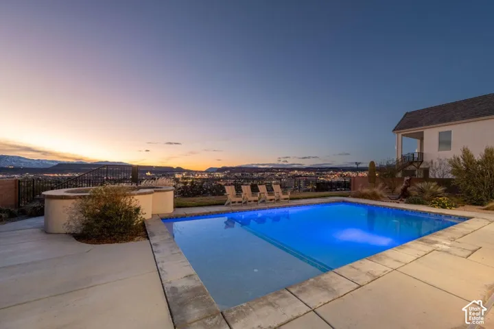 In-ground swimming pool with concrete surround