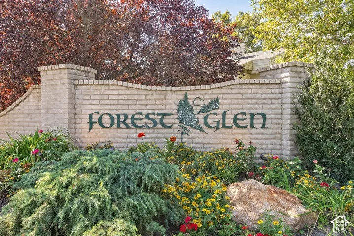 Brick signage with decorative lettering and an integrated tree motif
