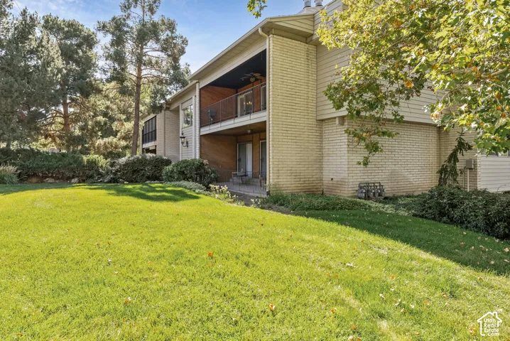 Expansive green lawn with mature trees and established perimeter landscaping