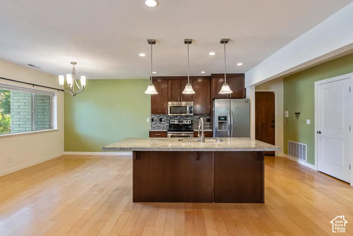 Kitchen island with granite-style countertop and pendant lighting