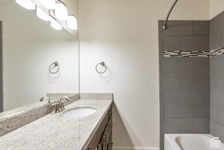 Vanity with a speckled countertop, undermount sink, and brushed nickel faucet