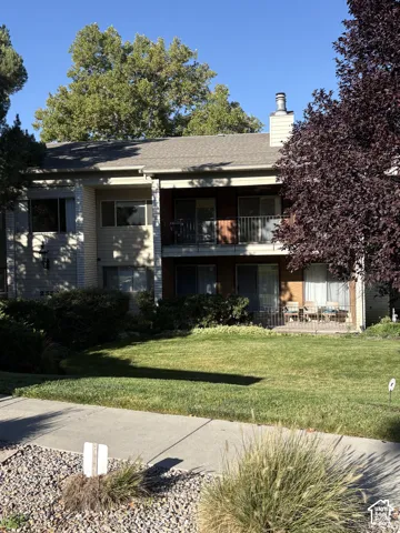 Two-story structure with a composition shingle roof and a stucco exterior