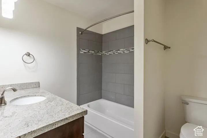 Vanity with stone countertop, undermount sink, and brushed nickel faucet