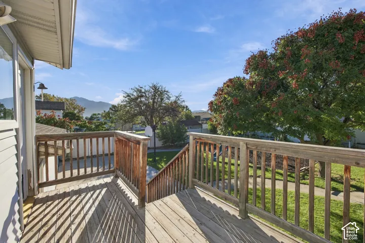 Hardwood deck with railings, exterior siding, and mountain scenery