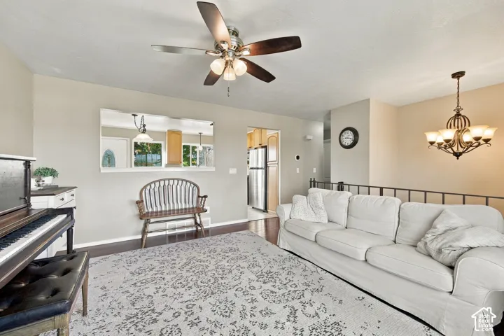 Recessed wall opening with built-in shelf, dark wood-finish flooring, and a ceiling fan with integrated lighting