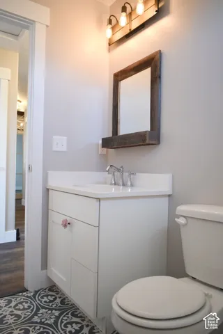 Bathroom featuring a white vanity with an integrated sink, polished chrome faucet, and white countertop