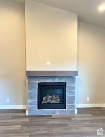 Fireplace featuring a stone surround and wood-finish mantel