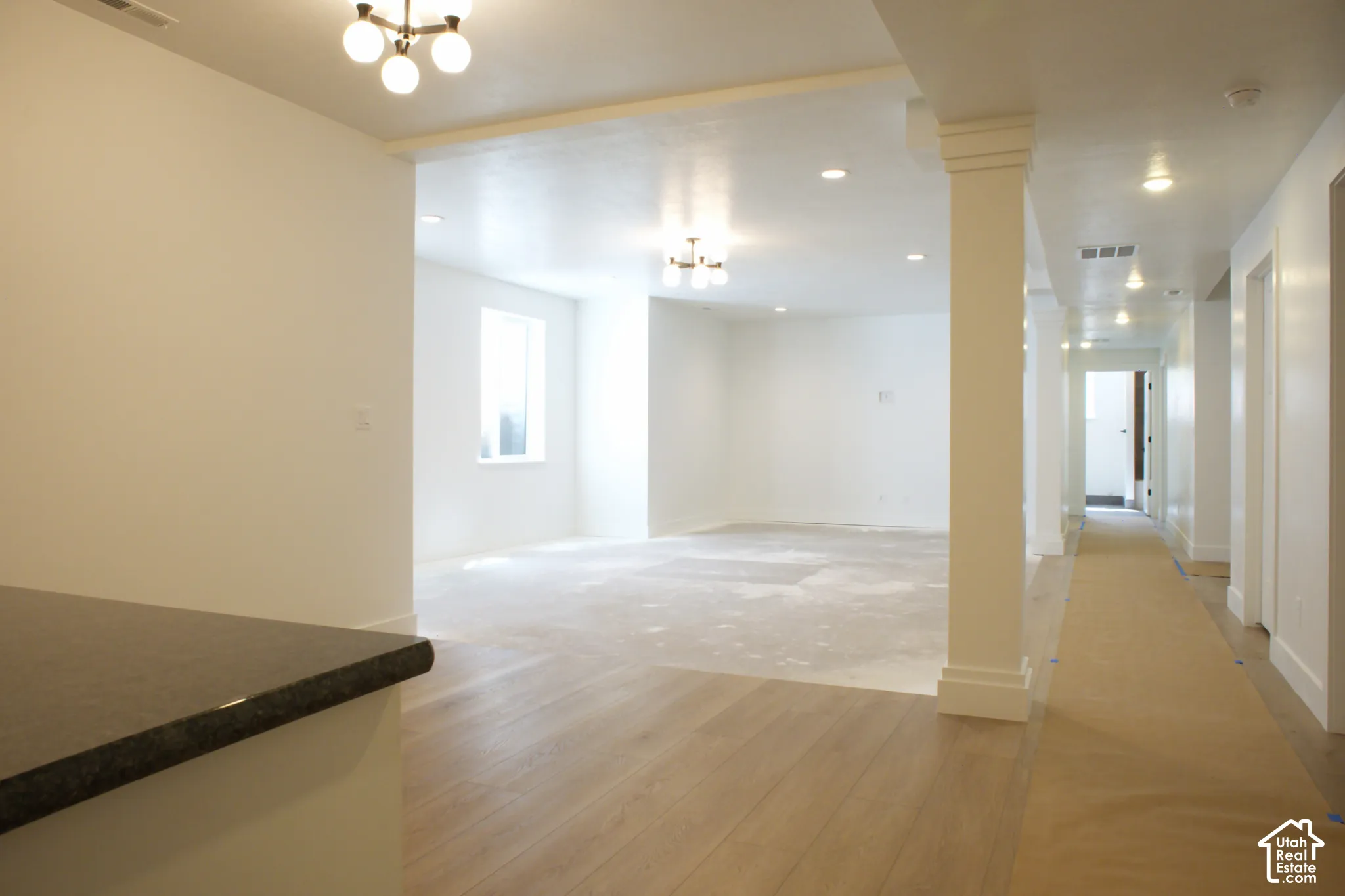 Hardwood-finish flooring, recessed lighting, architectural column, built-in countertop, and window