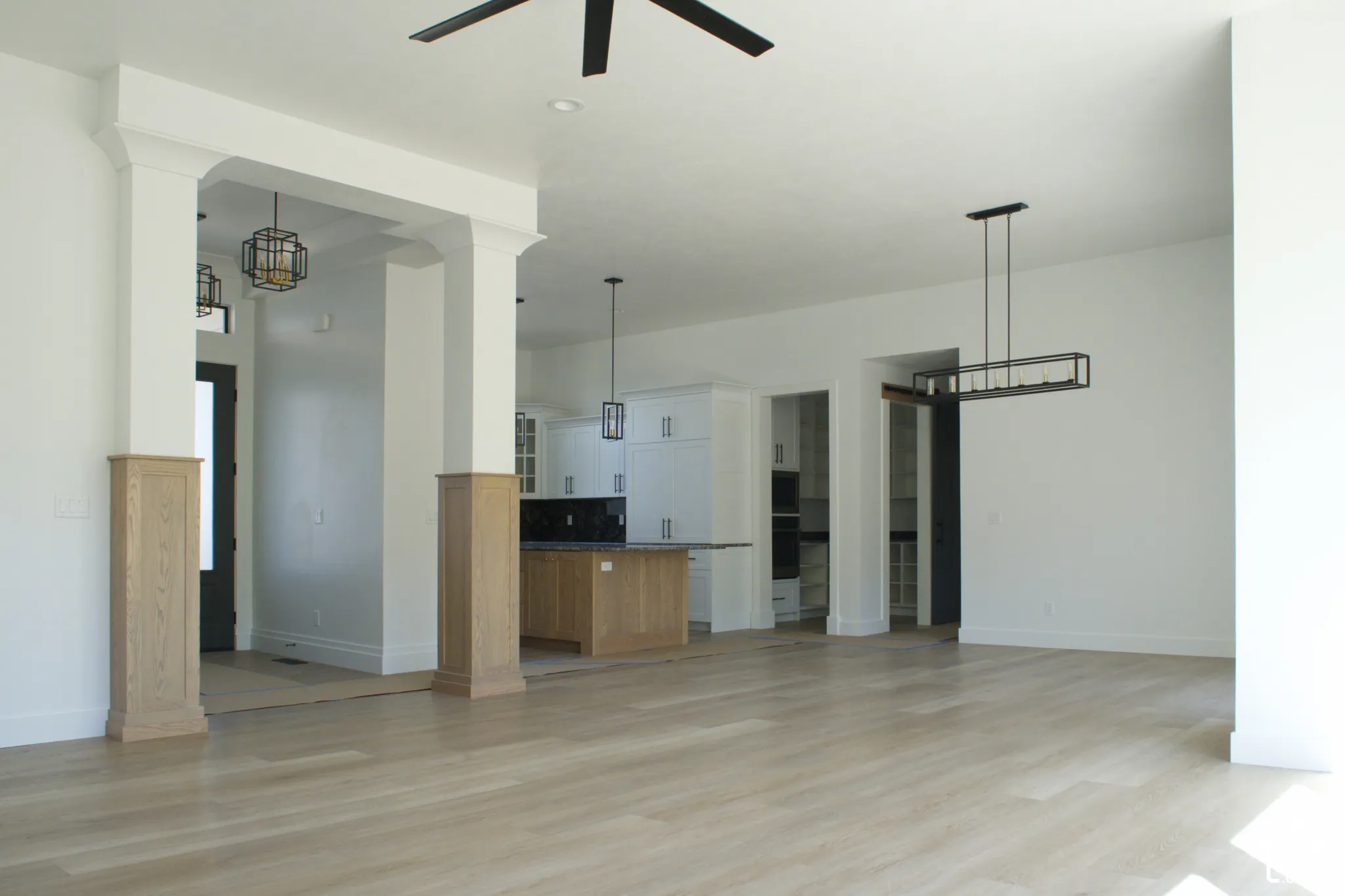 Light wood-finish flooring with white walls and trim