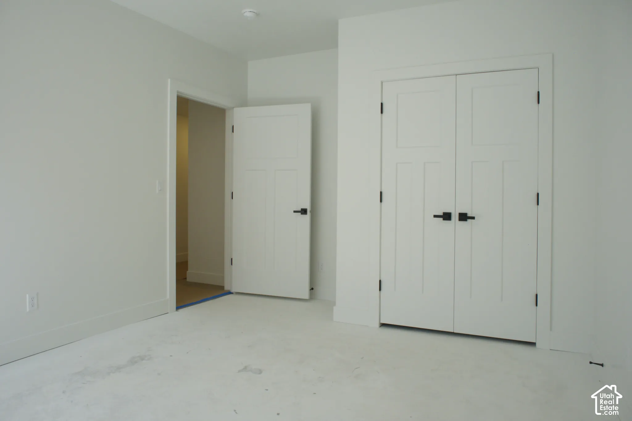 White interior walls, interior doors with matte black hardware, and an interior double-door closet