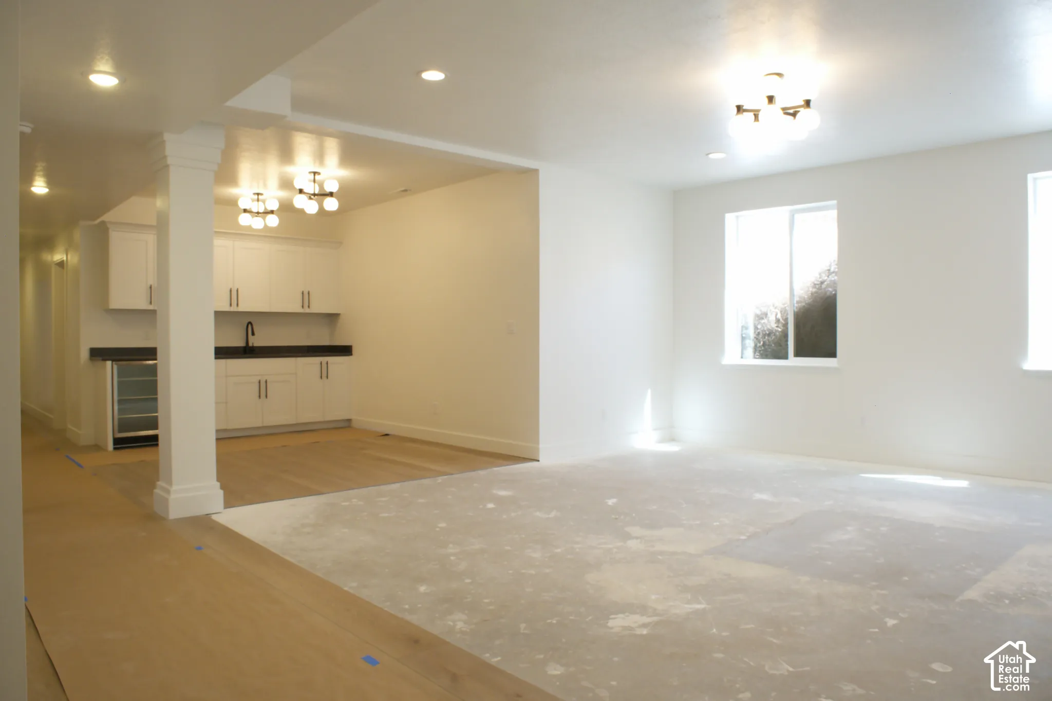 Recessed lighting, wood-finish flooring, built-in cabinetry, dual windows, and a beverage refrigerator