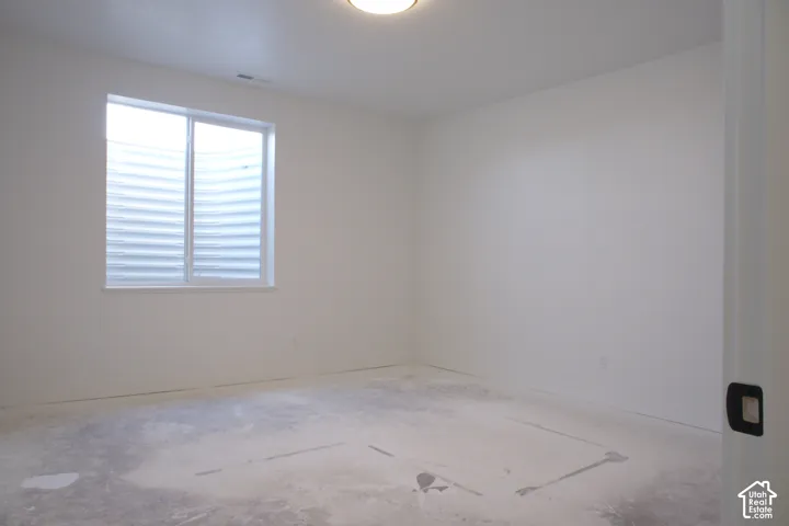 Single window with white frame, white painted walls, and overhead flush-mount lighting fixture