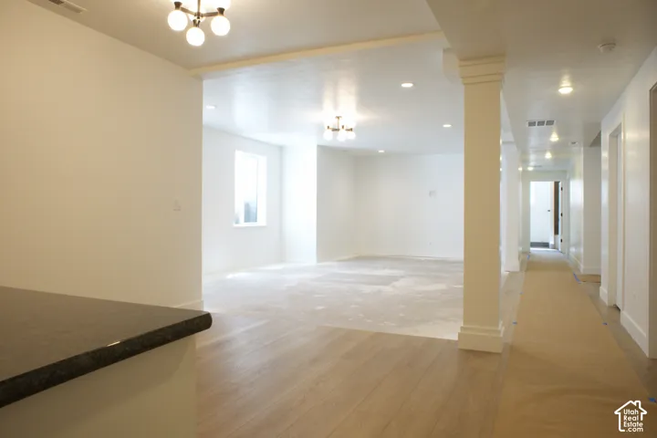 Hardwood-finish flooring, recessed lighting, architectural column, built-in countertop, and window