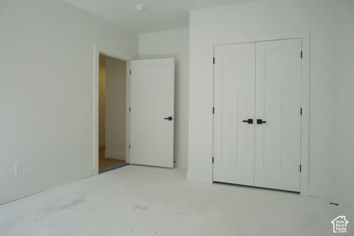 White interior walls, interior doors with matte black hardware, and an interior double-door closet