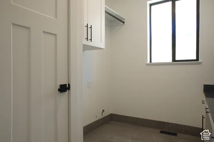 Modern white flat-panel cabinetry with matte black hardware