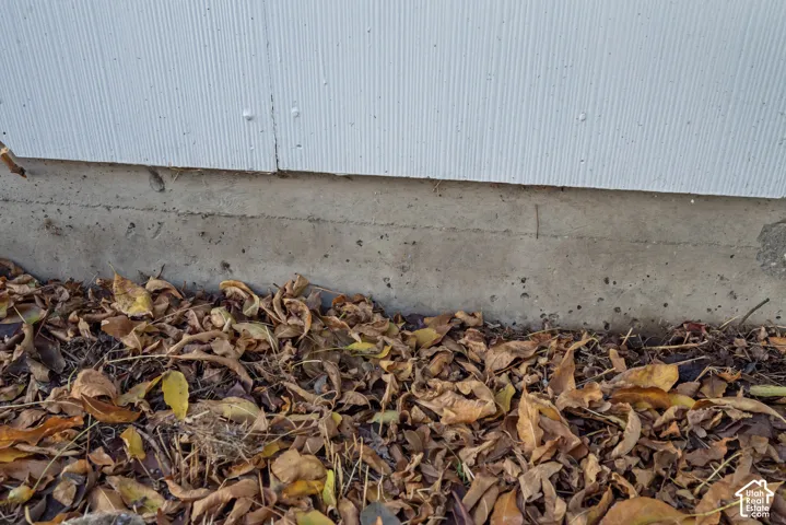 Exterior vertical panel siding with a concrete foundation
