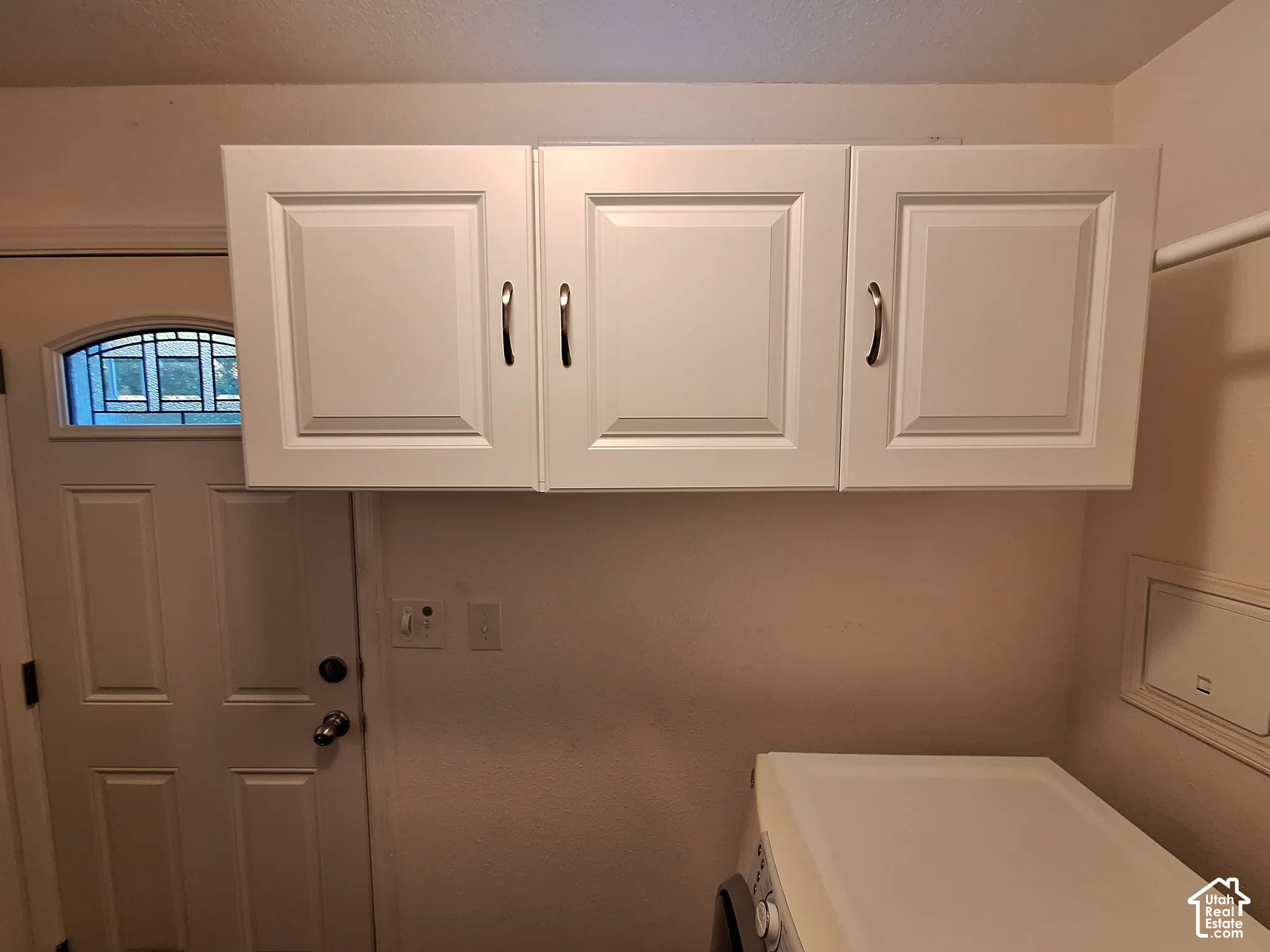 White shaker-style cabinetry with chrome pulls