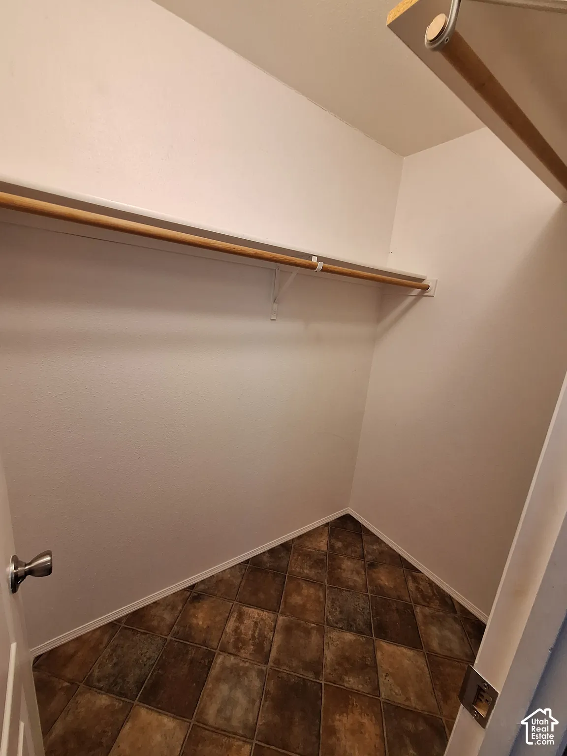 Built-in shelving and hanging rod with tile-look flooring