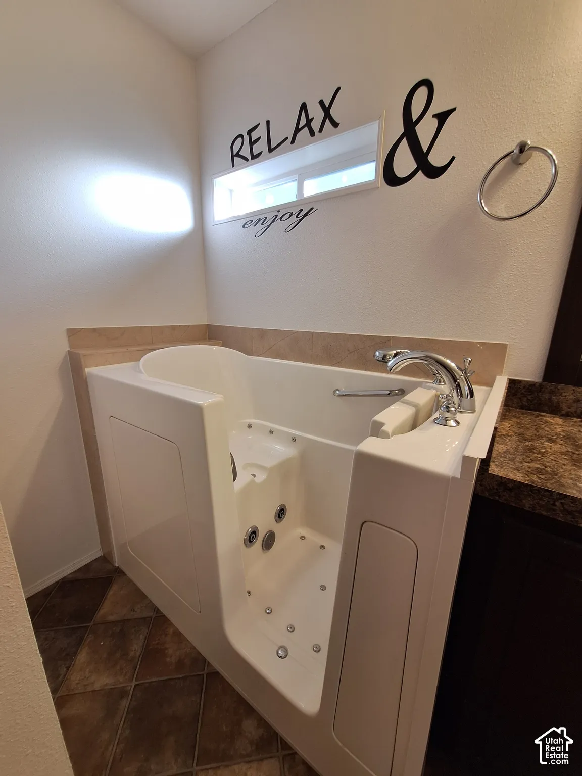 Walk-in tub with integrated jets and grab bar
