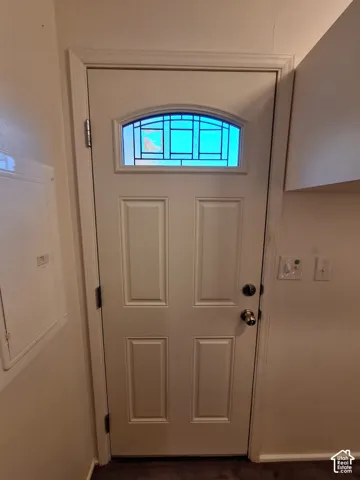 Paneled entry door with an arched transom window
