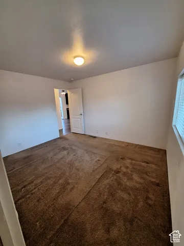 White interior walls complement the brown carpeting